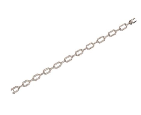 AN ART DECO PLATINUM BRACELETcomprising eleven geometric diamond set panels, linked by ten diamond set bars, and fastened by 