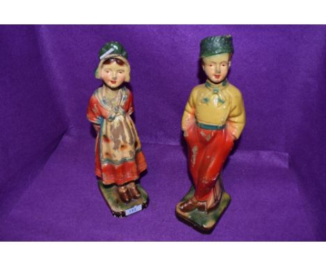 A pair of art deco chalk ware figurines of a boy and a girl.