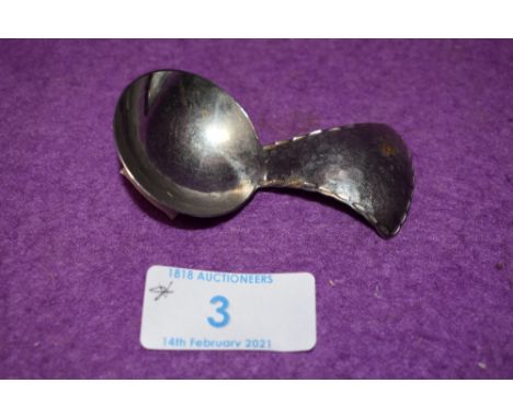 A Keswick school of industrial arts caddy spoon having hammered detailing, marked underside KSIA Keswick Firth Staybrite.