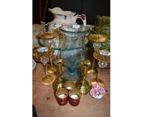 A mixed lot including brass and glass candle sticks and tea light holders.