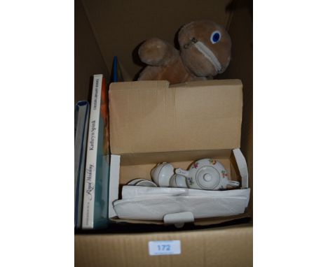 A box of general books, a childrens ceramic tea set and a zippy toy.