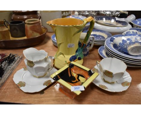 An art deco Victoria trio and milk jug, a Burleigh ware vase with bird to handle and yellow ground and a lustre Carlton ware 