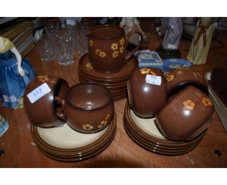 A selection of Denby tea cups and saucers in the Sandstone pattern