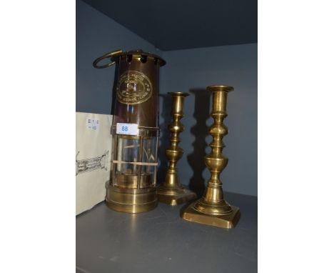 An E Thomas Williams Cambrian safety miners lamp no.80700 dated 1981 with certificate and a pair of candle sticks