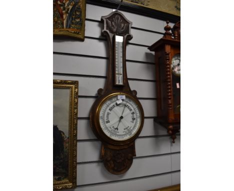 A vintage carved oak bodied barometer with enamel face dial glass AF