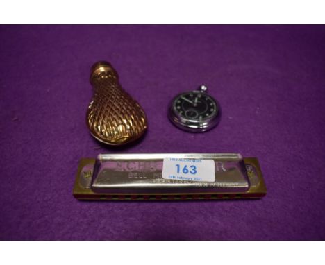 An embossed copper bodied 19th century shot / powder flask having brass collar,a Hohner harmonica and a mid century stop watc