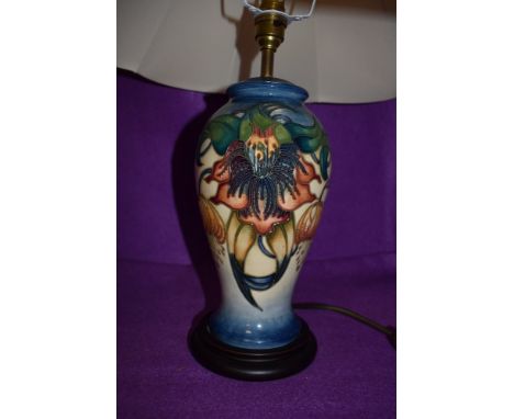 A Moorcroft Anna lily lamp base with shade, designed by Nicola Slaney,blue and cream ground with exuberant floral pattern.