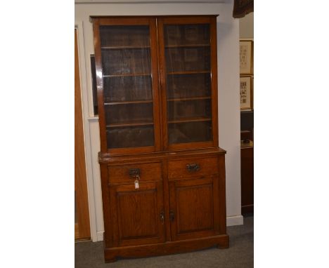 Arts and Crafts oak book shelf with lower drawers and cupboard. Adjustable shelves and mis matched Nouveau drawer handles. Wi