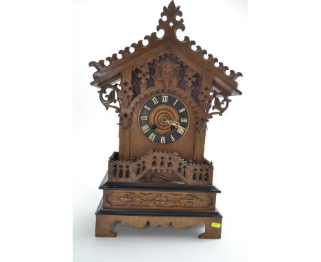 Late C19 Black Forest style oak cased cuckoo bracket clock with ebonised trim. H62.5cm W39cm D21cm Areas of loss, top left pe