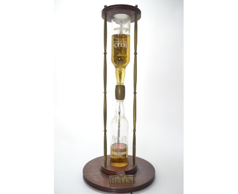 A novelty light-up liquid hour glass, with Bell's Whisky bottles & coloured fluid filling (not Whisky). H67cm. 