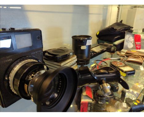 Mamiya Universal camera with no. 101105 lens & other related accessories on shelf 