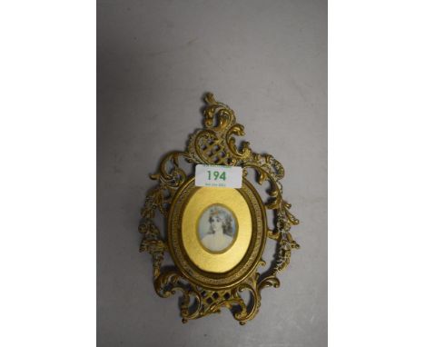 A late 19th / early 20th century portrait miniature on ceramic or similar in ornate brass frame.