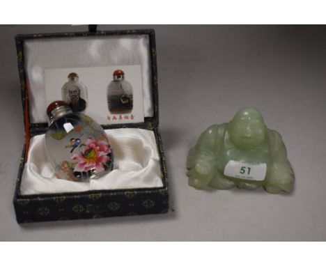 A Jade figure modelled as seated budda and an Oriental tourist perfume bottle