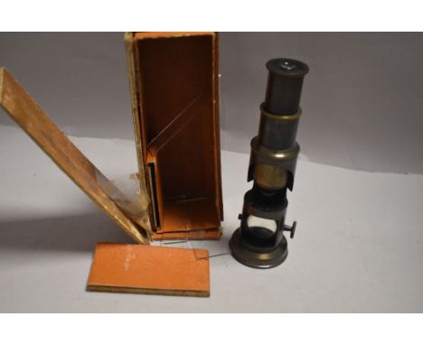 A vintage College microscope in original case