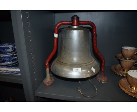 A 1950's fire station alarm bell having red metal bracket and large bell with ringer