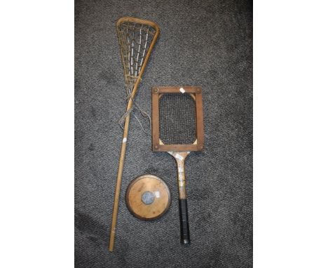 A vintage LaCrosse stick, tennis racket and discus