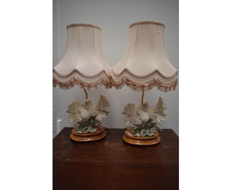 A pair of modern/vintage table lamps, modelled as kissing doves, Capo di Monte style, labelled G Armani
Both lamps appear fre