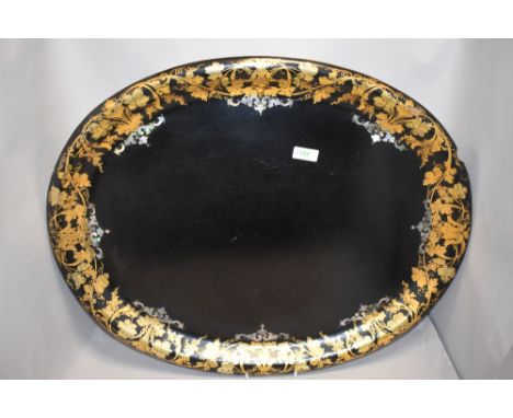A large Victorian papier mache tray decorated with gilt and mother of pearl inlay