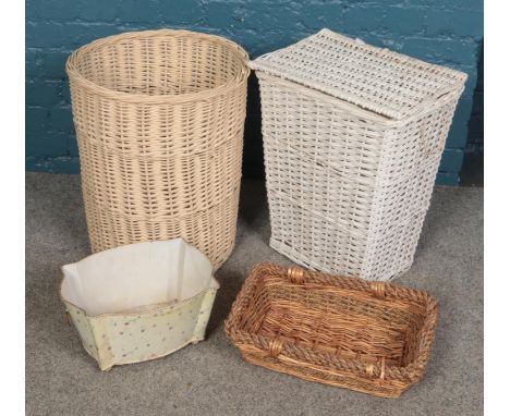 Three wicker baskets and a painted metal planter.  