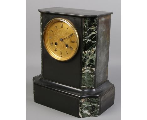 An eight day slate mantel clock with verdigris marble decoration and gilt dial. Chiming on a bell.  Includes pendulum but no 