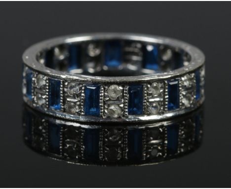 A 9ct white gold eternity ring set with blue and clear stones. Size R. 4.6g.  