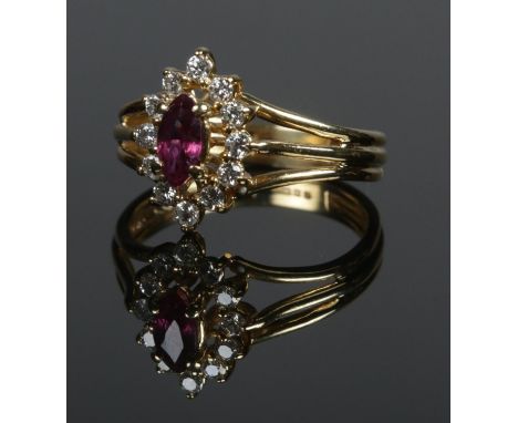 An 18ct gold ruby and diamond cluster ring. Size L. 3.83g.  