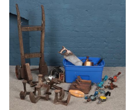 A large assortment of tools. To include planes, manual hand drills and cast iron shoe formers etc.  