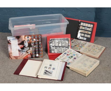 A quantity of stamp albums, tea cards &amp; England 1998 football team medal collection. To include First day covers etc  