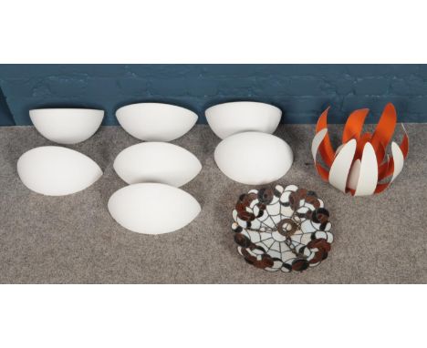 A box of assorted light fittings. To include seven ceramic wall lights, a Tiffany style pendant and metal petal pendant.  