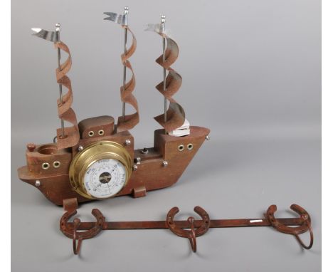 A novelty lamp/barometer formed as a ship along with a metal horse shoe coat hook.  