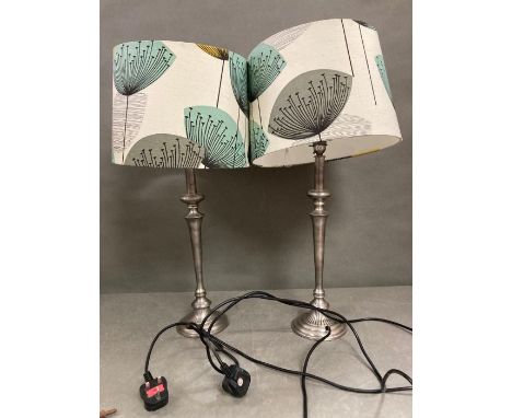A pair of lamps with dandelion print lamp shades 