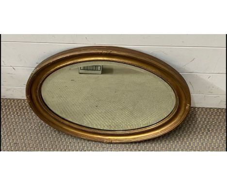 An oval gilt mirror (52cm)
