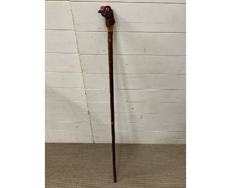 A shooting stick with carved red grouse head, stamped CW and Splits for transportation 