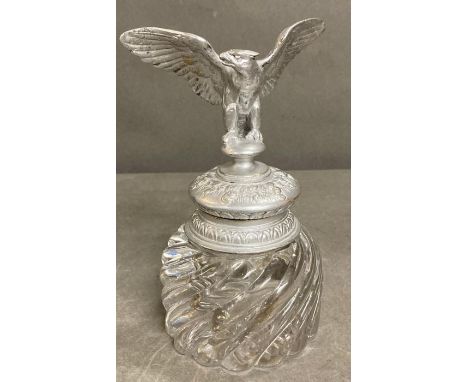 A glass inkwell with an eagle top 