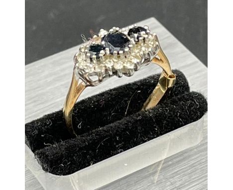 A 9ct sapphire and diamond three stone ring Size M