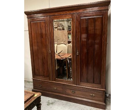 A triple mahogany wardrobe with mirror and two drawers under (H208cm W188cm D58cm)