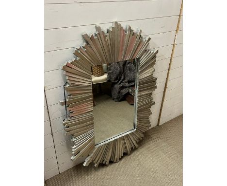 A silver wall mirror with plank style frame in a starburst style.