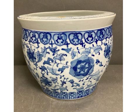A large blue and white ceramic planter 