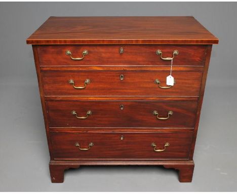 A GEORGIAN MAHOGANY CHEST, c.1800, the moulded edged top with stringing, four graduated drawers with brass drop handles, pine
