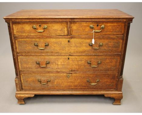 A GEORGIAN OAK CHEST, late 18th century, the moulded edged top over two short and three long crossbanded drawers flanked by f