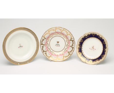 THREE ENGLISH PORCELAIN ARMORIAL DISHES comprising a Spode soup plate, c.1820, with two green fish within a pink and gilt bor