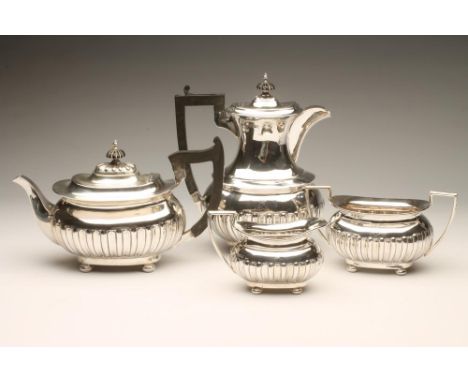 A LATE VICTORIAN SILVER FOUR PIECE TEA AND COFFEE SERVICE, maker Walker & Hall, Sheffield 1897, of semi-fluted rounded oblong