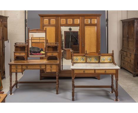 A VICTORIAN AESTHETIC WALNUT PART BEDROOM SUITE by Gillow, Lancaster, with parquetry inlaid oak panels, and comprising a trip