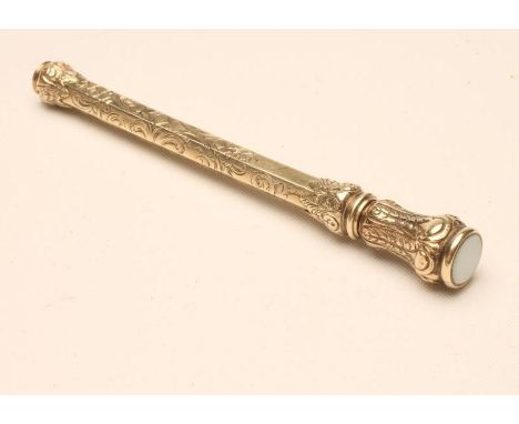 A VICTORIAN GILT METAL TELESCOPIC PENCIL of hexagonal form, unmarked, bright cut engraved with scrolling foliage and with pol