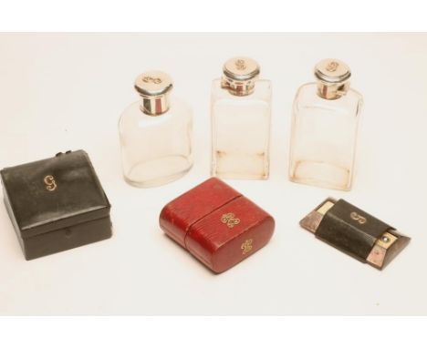 A GENTLEMAN'S TRAVELLING PART SILVER DRESSING SET, maker Finnegan's, London 1923/27/35, comprising two tall bottles with pate