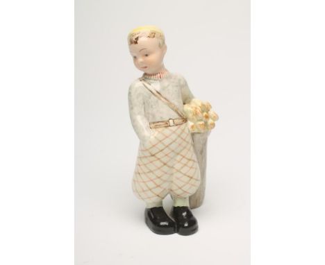 A GOLDSCHEIDER EARTHENWARE FIGURE, 1930's, of a young boy golfer, wearing a yellow beret, grey marl jumper and tartan plus fo