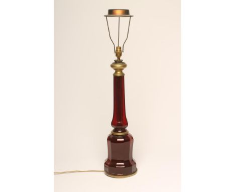 A RUBY GLASS  ELECTRIC TABLE LAMP BASE, c.1930's, the swept octagonal stem issuing from a multi panelled domed base and panel