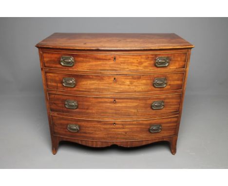 A REGENCY MAHOGANY CHEST of bowed form, the moulded edged top over four graduated cockbeaded drawers with oval brass drop han