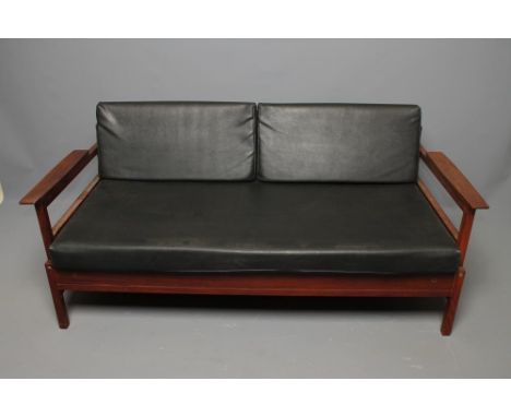 AN ENGLISH TEAK FRAMED SOFA BED, 1960's, with loose cushions in black leatherette, angled single plank back, shaped arms, on 