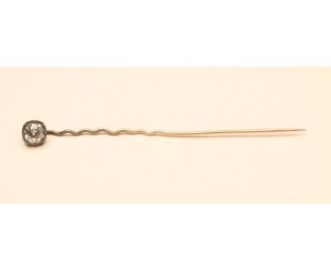 A DIAMOND STICK PIN, the cushion cut stone close back collet set to a wavy pin (Est. plus 18% premium inc. VAT)